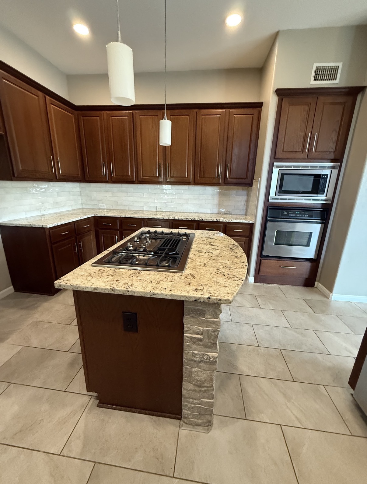Dated kitchen with brown cabinets before the remodel
