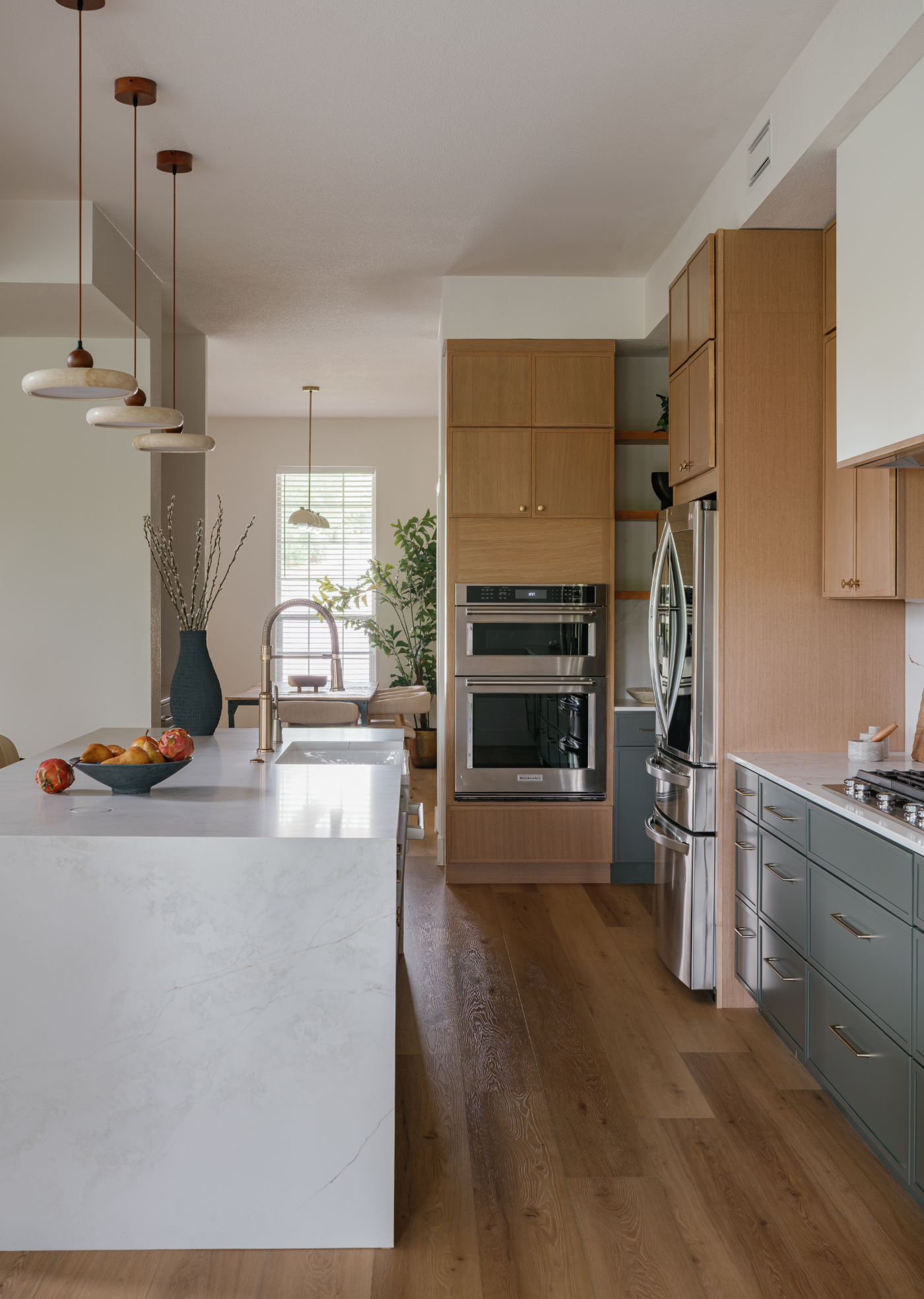 Kitchen with green lower cabinets after the remodel