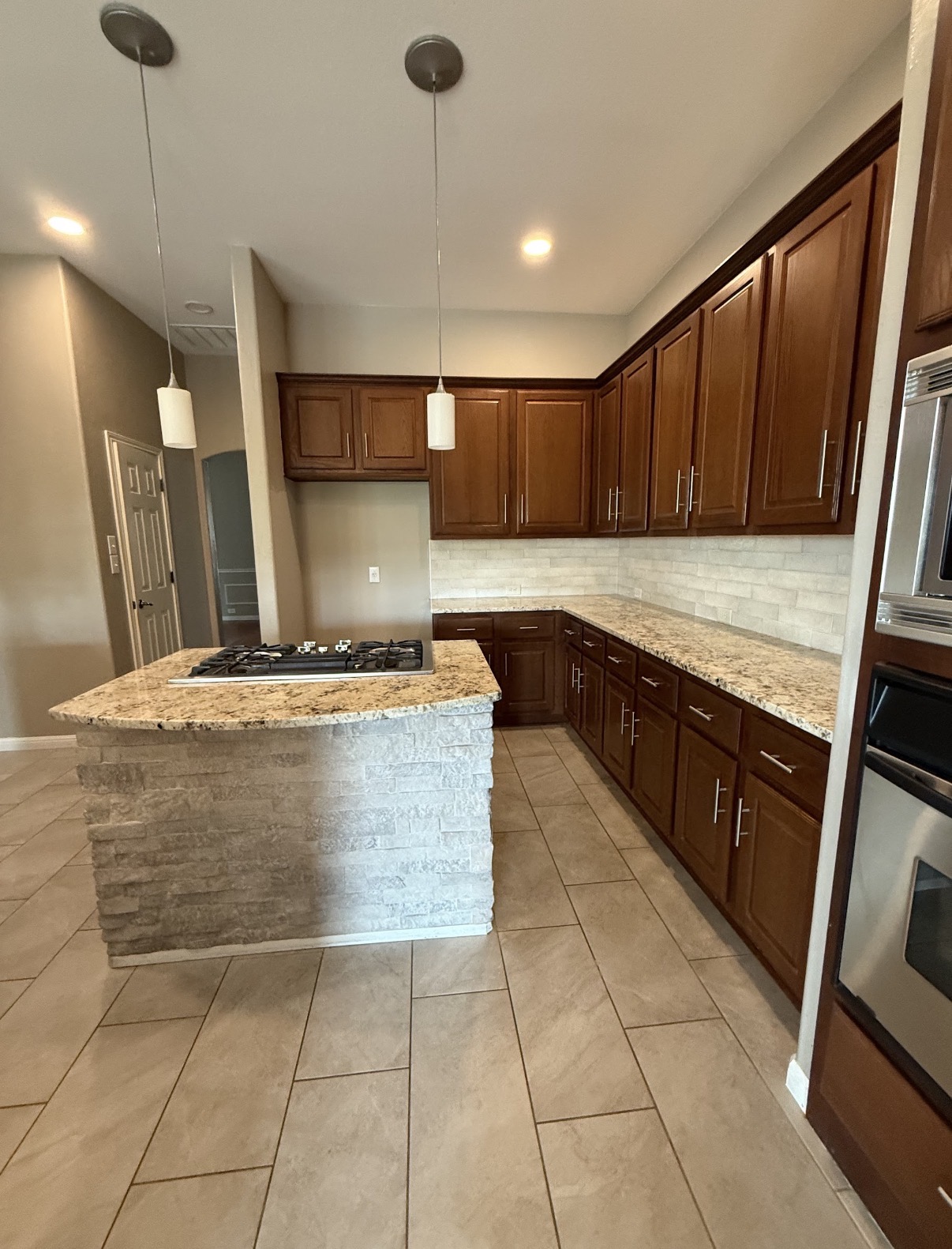 Dated kitchen with brown cabinets before the remodel