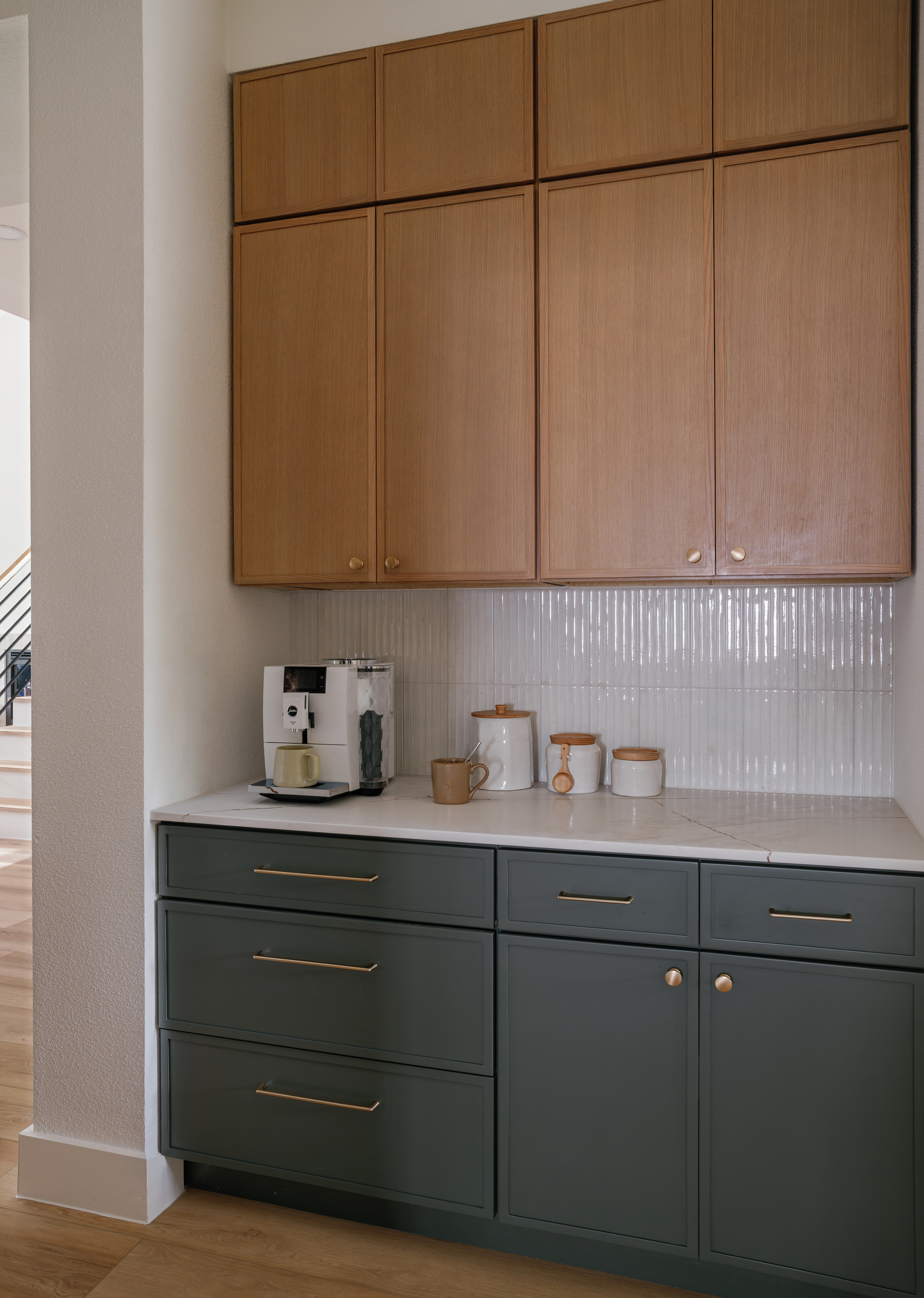 Coffee station with oak cabinets and green drawers