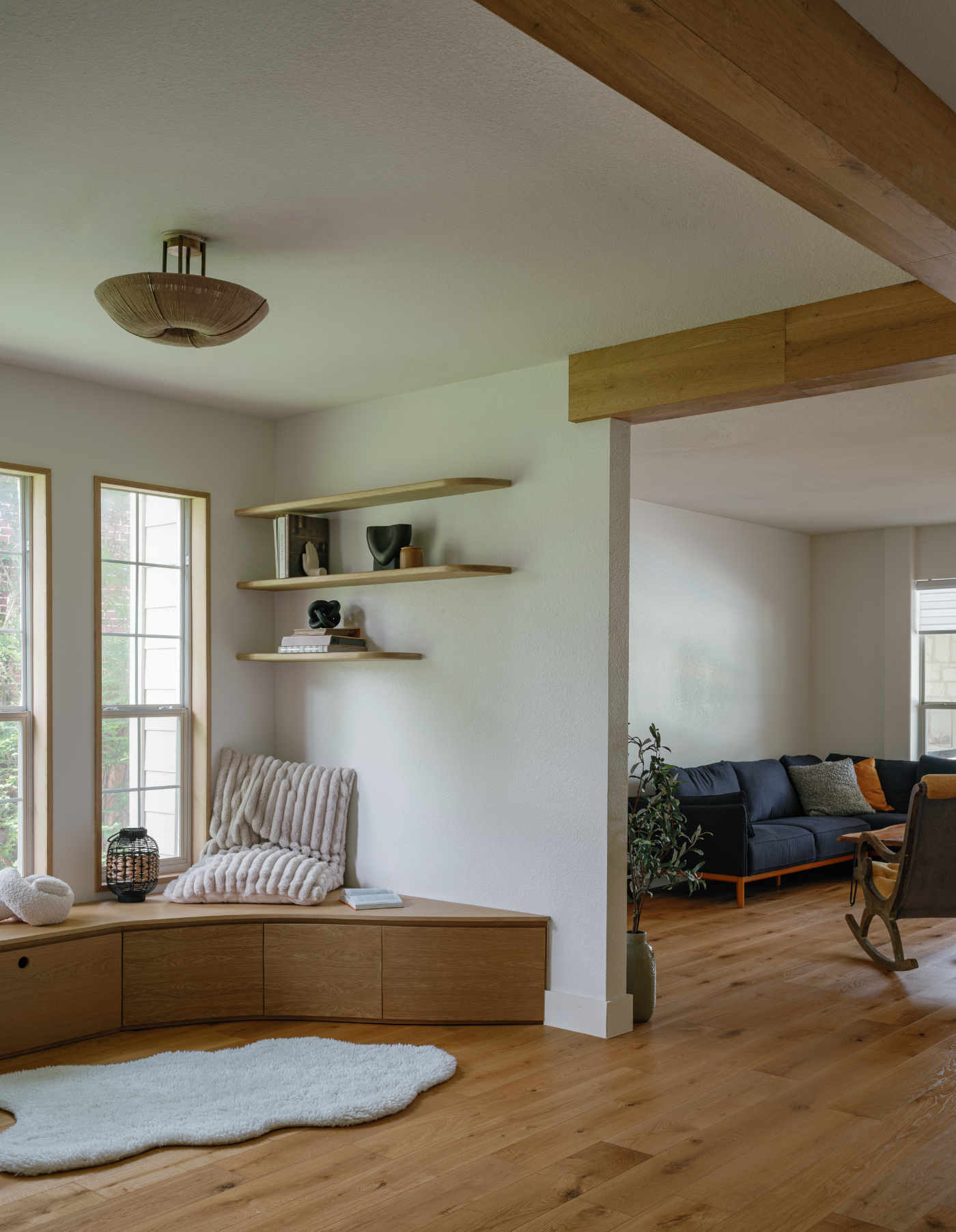 Open living area with wood beam