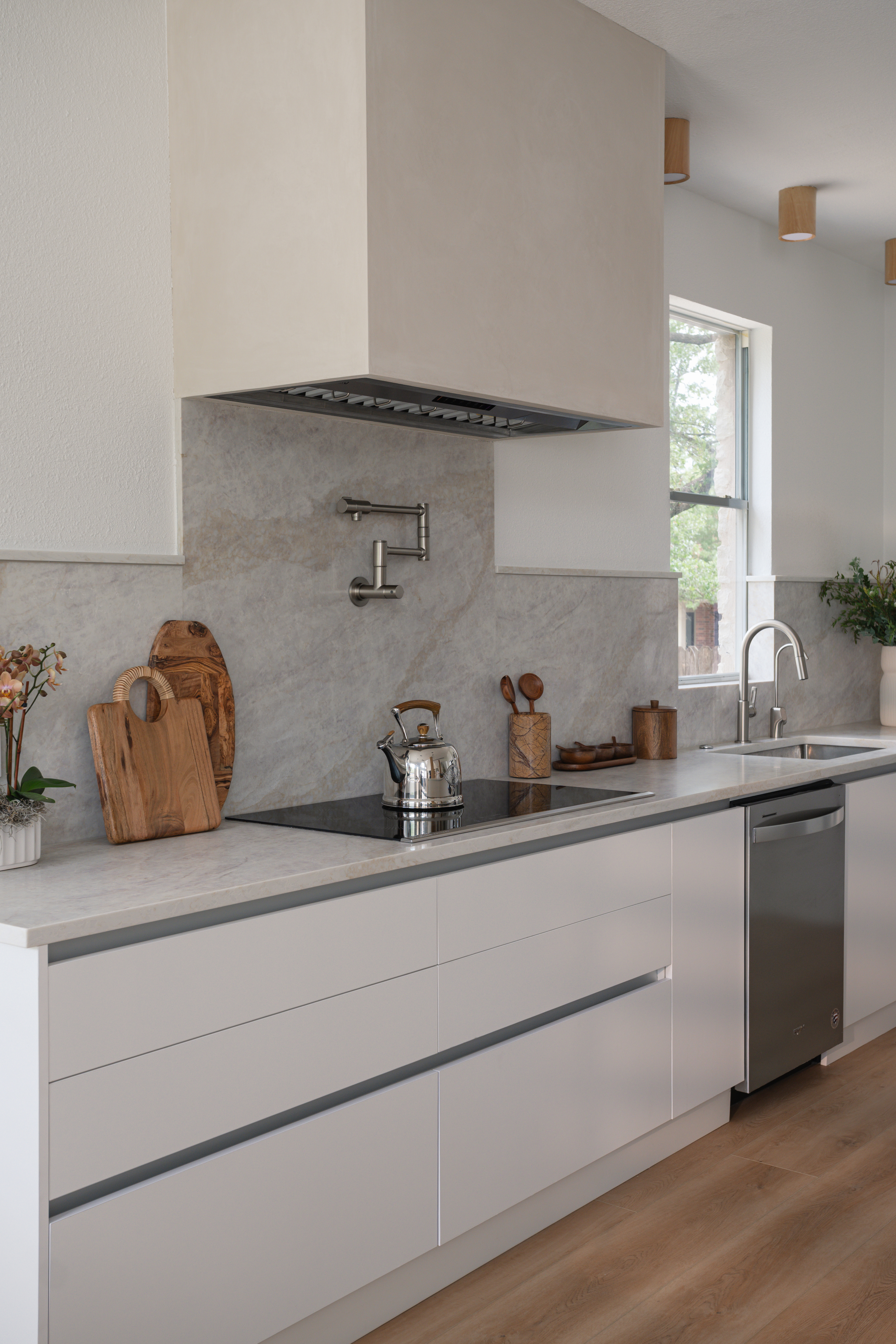 Cooktop with plaster hood and marble backsplash
