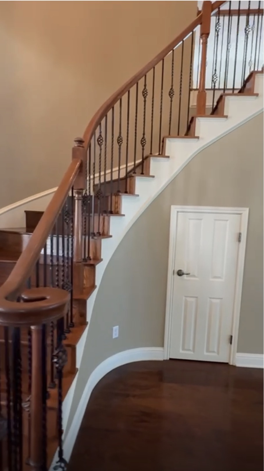 Curved staircase with under-stair closet before the remodel
