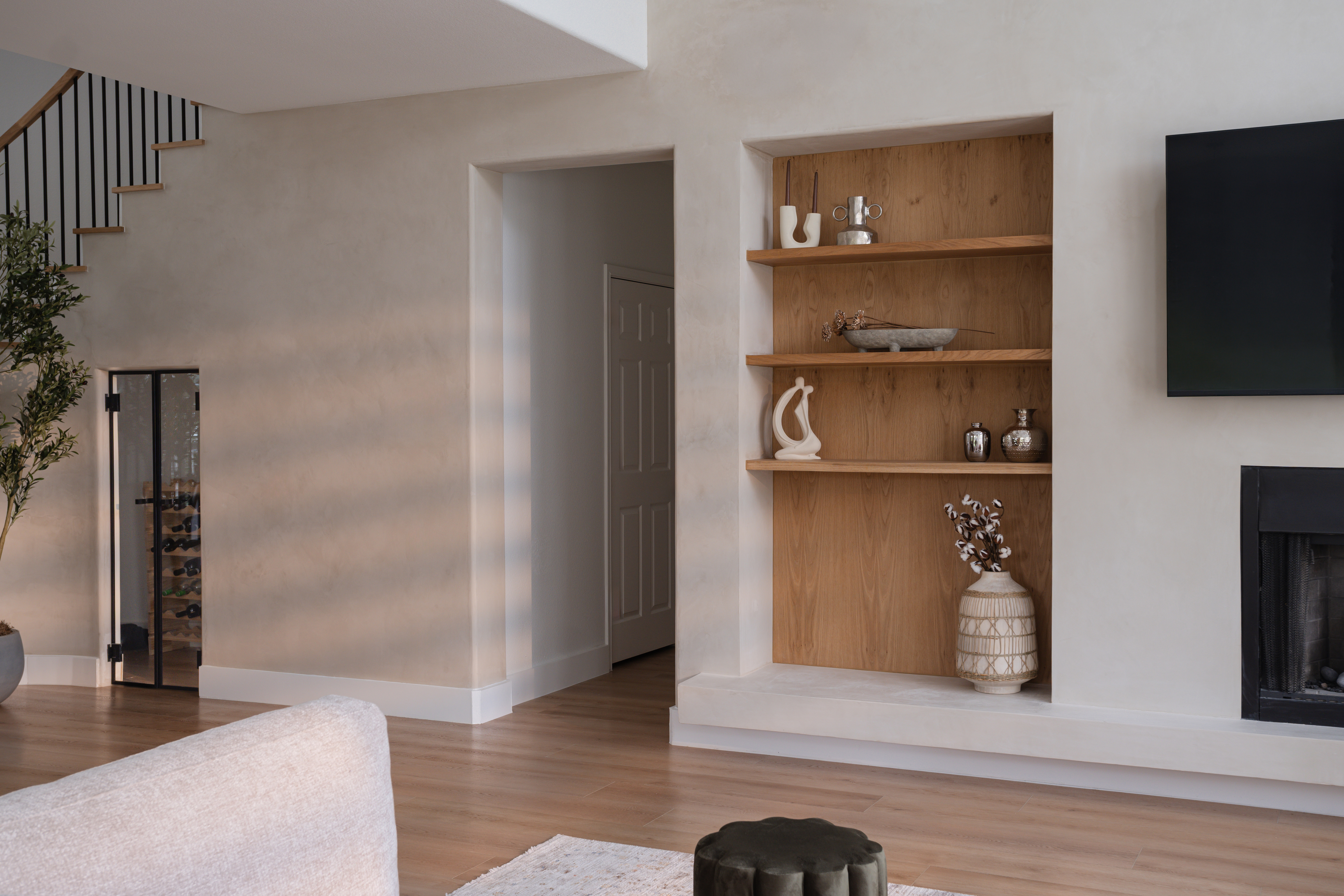 Plaster built-in shelving beside fireplace