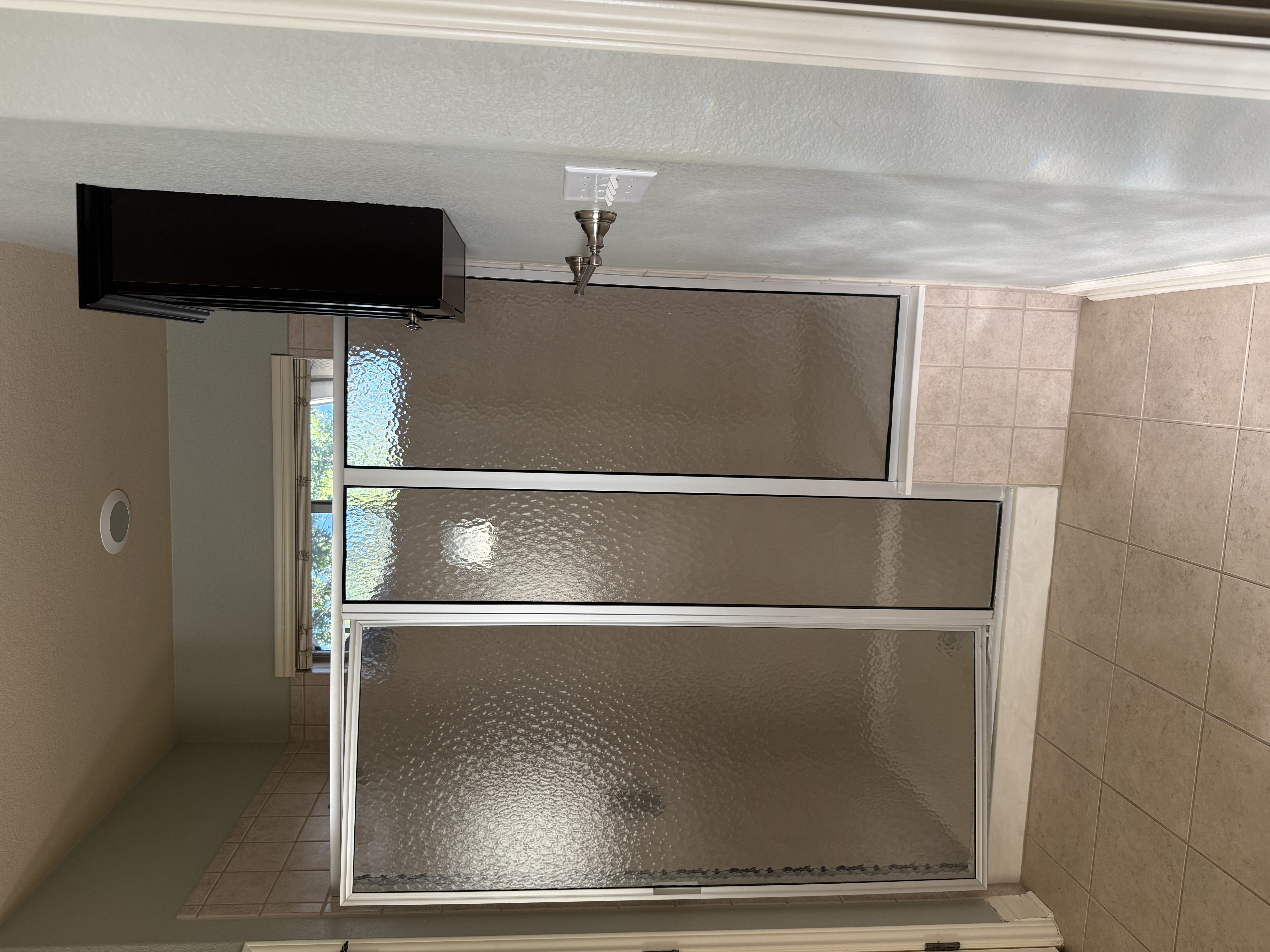 Dated shower enclosure before the remodel
